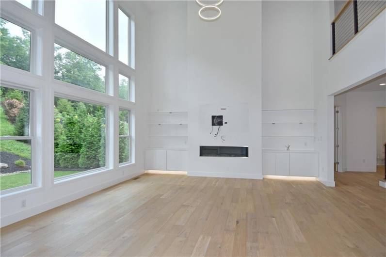 A massive window wall and contemporary built-in's with specialty lighting highlight the 2 story family room.
