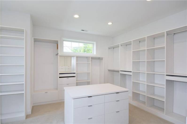 Enjoy this oversized custom closet in the primary suite.  There is a second walk-in located in the bath.
