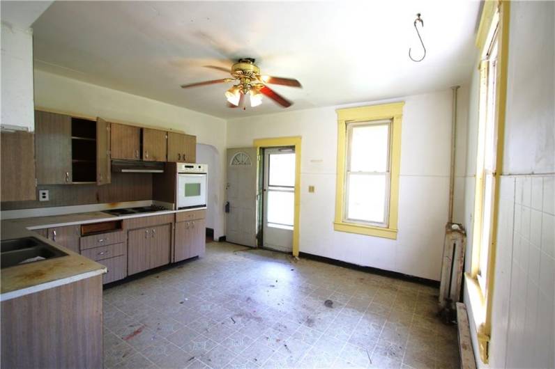 Big 14x13 Eat-in Kitchen w/ Plenty of Cabinet Space & door to front yard