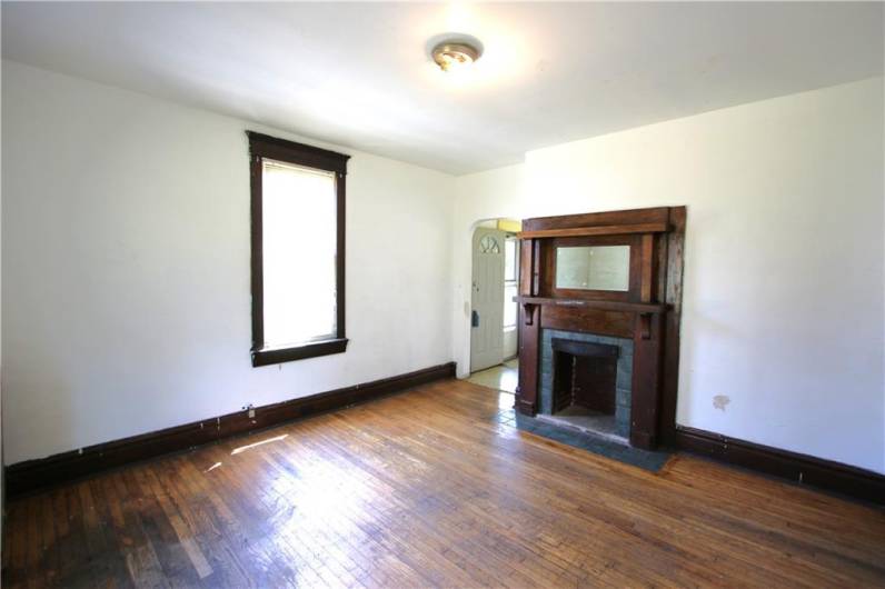 Separate 15x13 Dining Room w/ Gorgeous Woodwork around Fireplace. Original Hardwood Floors need refinished and brought back to their beauty! Quality Wood Trim & Baseboard