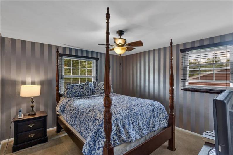 Primary bedroom with neutral carpeting and spacious closet