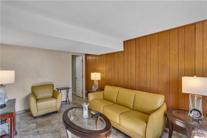 Comfy cozy lower level family room. Door in back to powder room