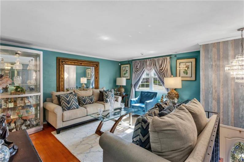 Spacious living room with hardwood floors and large front picture window