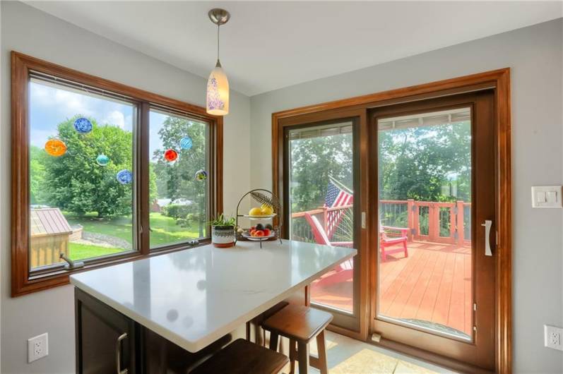 Enjoy abundant natural light and scenic backyard views from this charming breakfast nook, highlighted by energy-efficient Pella sliding glass doors. Step right out onto the spacious deck—perfect for seamless indoor-outdoor living.