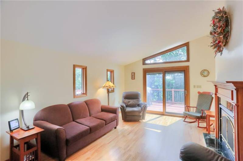 The family room features vaulted ceilings and abundant natural light, creating an open and airy feel. Enjoy easy access to the deck through sliding glass doors—perfect for relaxing or entertaining with a seamless indoor-outdoor flow.