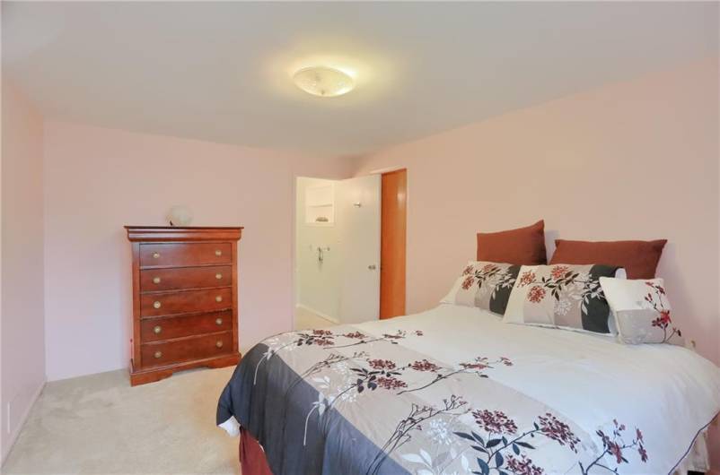 Spacious en-suite features a private half bath.