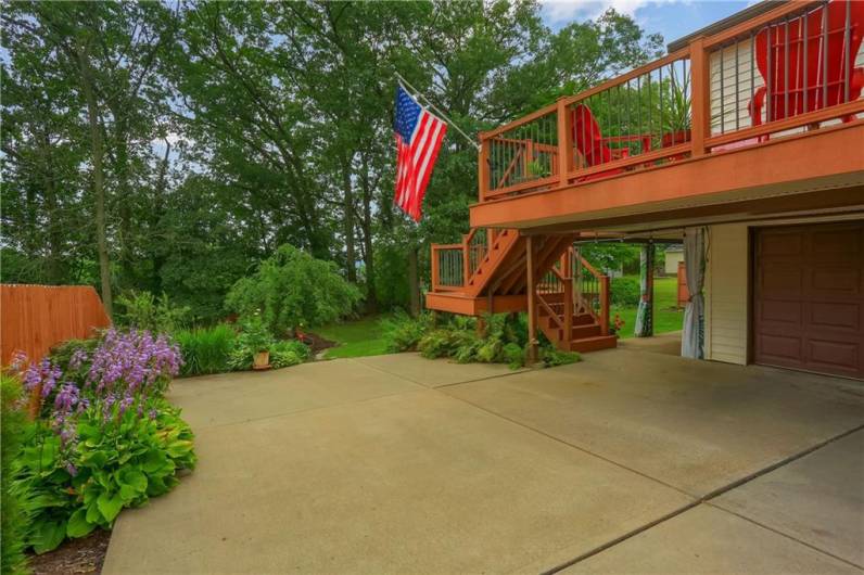 The spacious driveway leads to a two-car garage and offers plenty of parking and outdoor space. A beautiful elevated deck overlooks the lush backyard, creating the perfect spot for relaxing or entertaining.