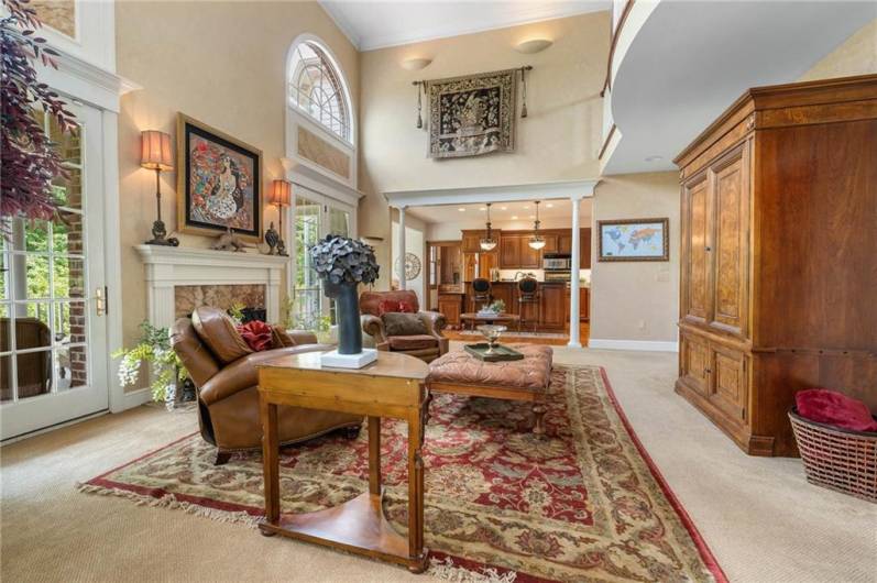 Notice the charmingly curved "balcony" catwalk on the second floor that overlooks this elegant space.