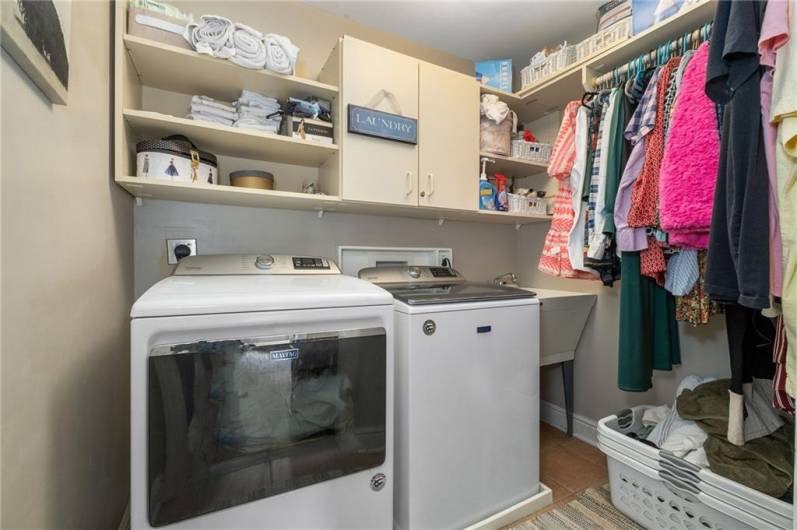 Second floor laundry with a laundry tub and storage!