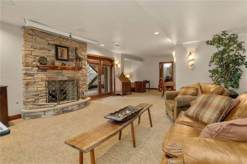 The finished basement is highlighted by a beautiful stone, wood-burning fireplace, a drop down movie theater screen and doors out to the back porch and large, flagstone back patio