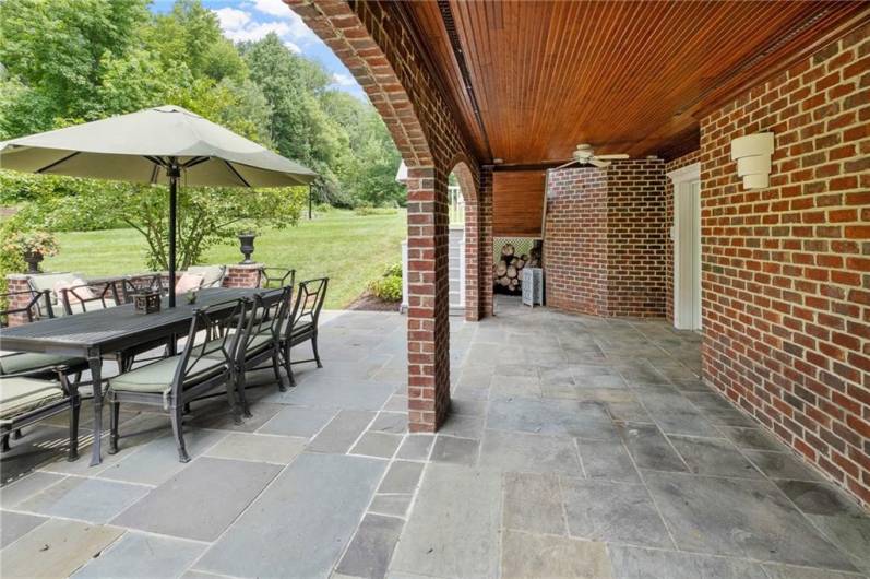 The brick arches and the gorgeous hardwood ceiling create the most charming atmosphere as you step out of the basement onto the flagstone patio.