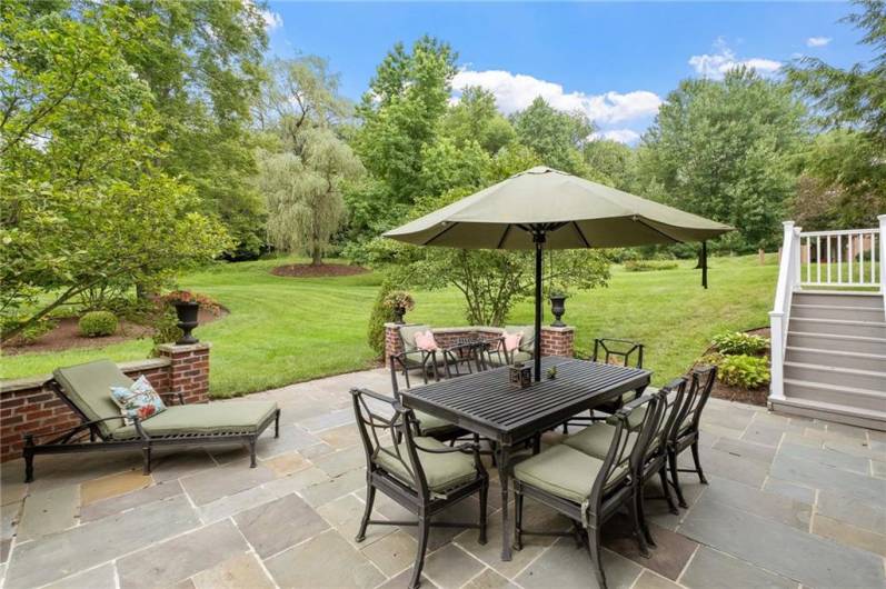 From the flagstone patio you have views of the beautifully landscaped backyard.