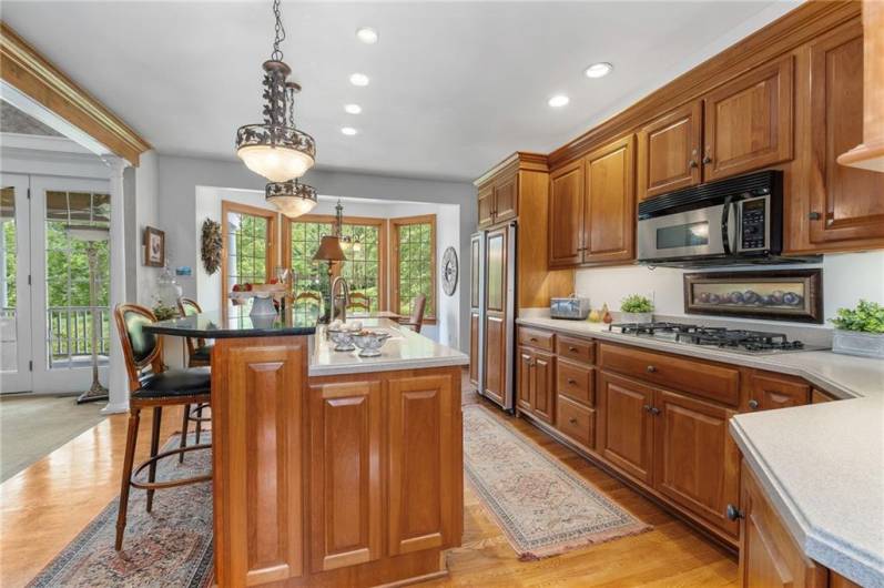 The stunning custom kitchen features high-end cabinetry, plenty of storage and lots of counter space.