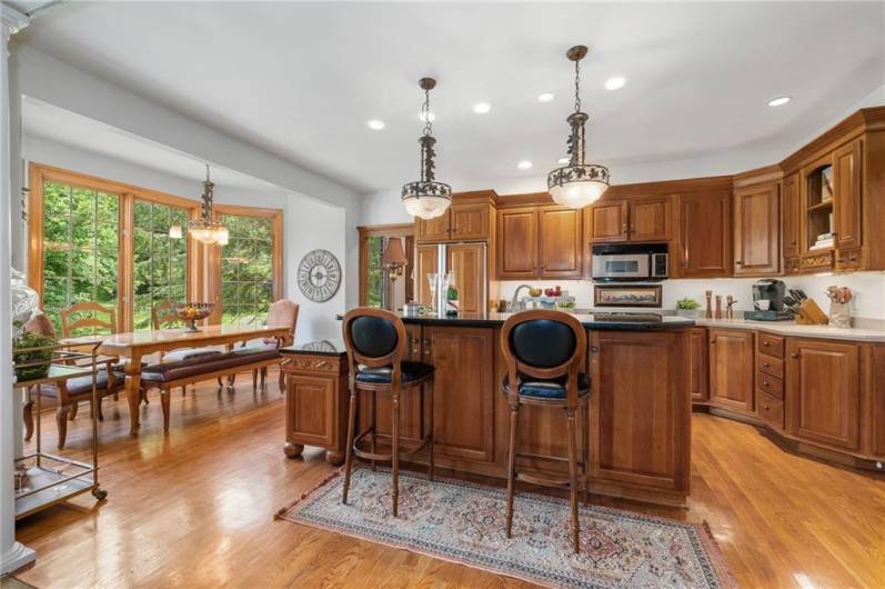 This lovely kitchen is light and bright, featuring warm wood tones, natural light and luxury to spare.