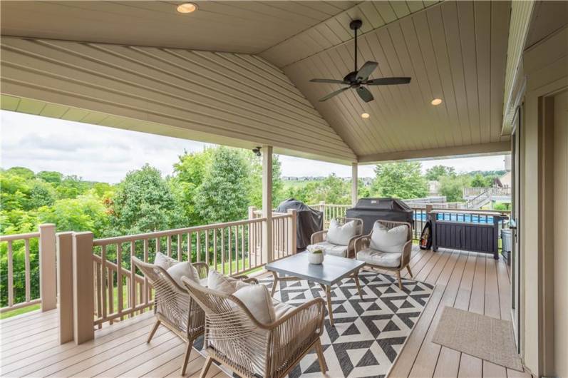 With steps leading to the lower level, this impressive deck features a grilling area, plenty of space for comfortable outdoor seating, and beautiful views—making it the perfect setting for both relaxing and entertaining.