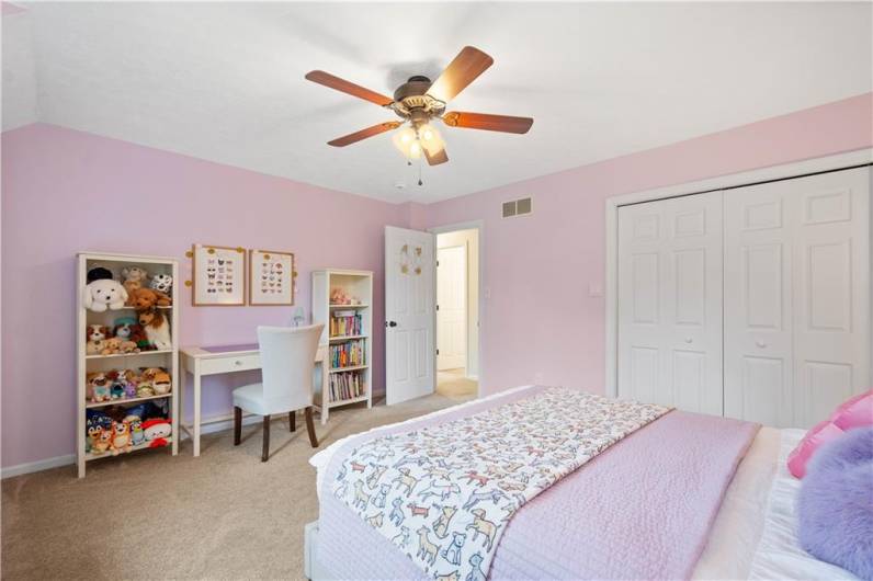 Bedroom 2 features a generously sized closet, a ceiling paddle fan, and ample wall space—providing both comfort and versatility.