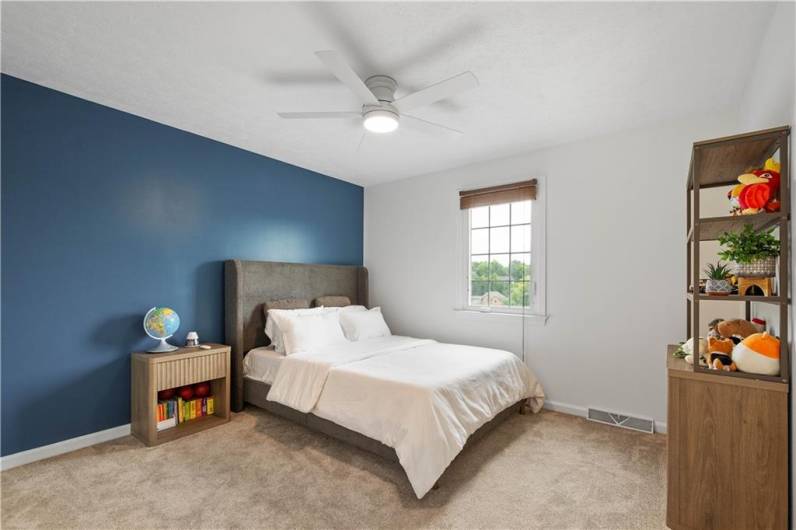 Bedroom 4 is spacious and bright, with white walls highlighted by a stylish accent wall.