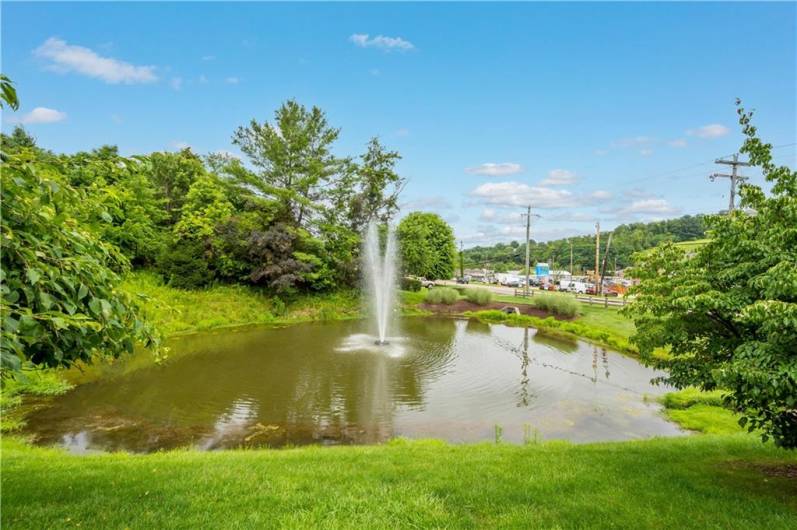 McClelland Farms welcomes you with a picturesque pond and fountain at the entrance, creating a serene and inviting community atmosphere.