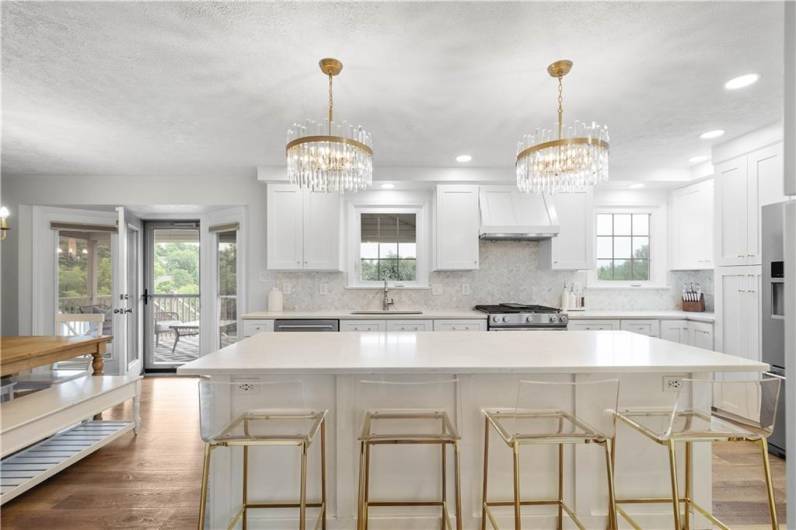 Sleek, stylish, and made for modern living—this kitchen wows with statement lighting, a streamlined center island for prep or casual dining, stainless steel appliances, and clean lines throughout. Ample cabinets and counter space keep things functional, while easy access to the covered deck makes indoor-outdoor living a breeze.