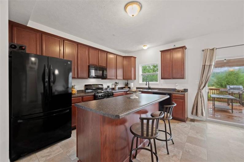 Start your day with a hot cup of coffee at the oversized kitchen island that can comfortably fit three barstools.