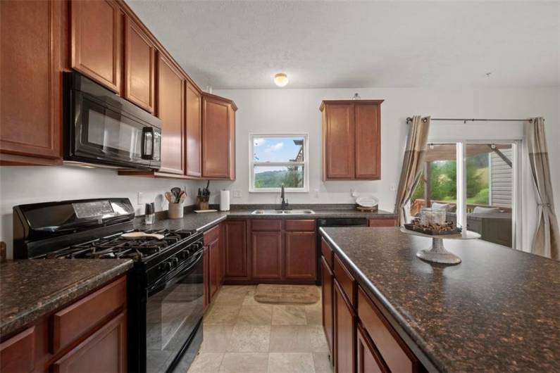 You will appreciate the coordinating black appliances including the 5 burner gas stove.