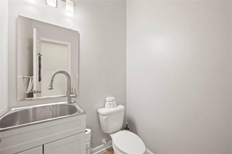 The seller put a utility type sink in the powder room to offer versatility to the space to have a larger sink to use when needed.