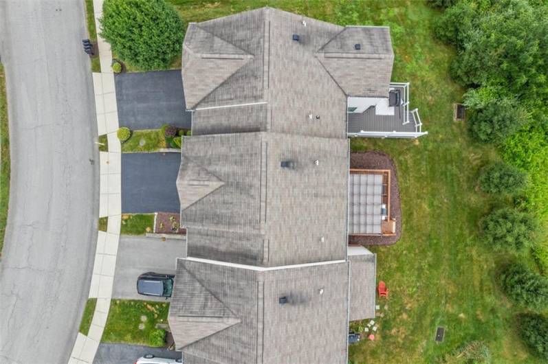 Aerial shows nice oversized deck with privacy in the back yard.