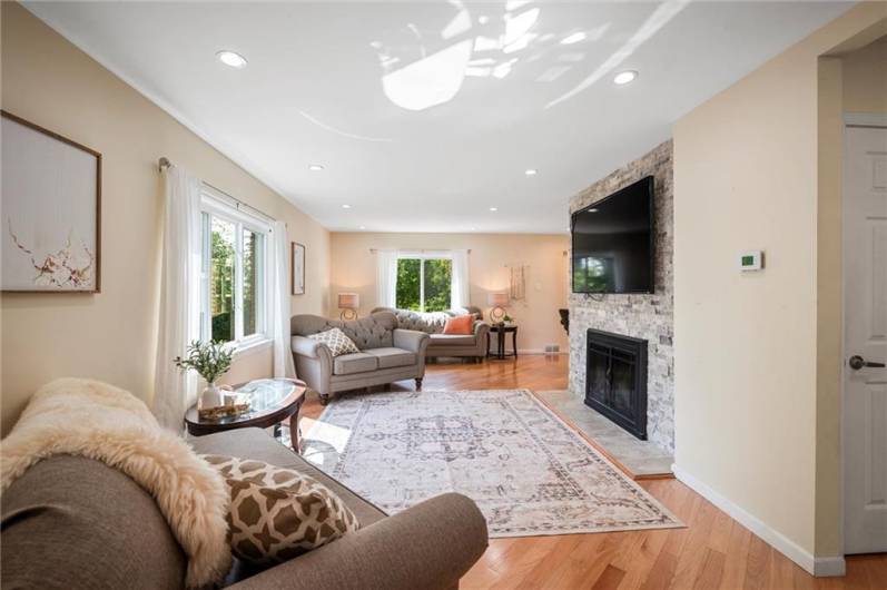Large and sunny living room with a wood burning fireplace