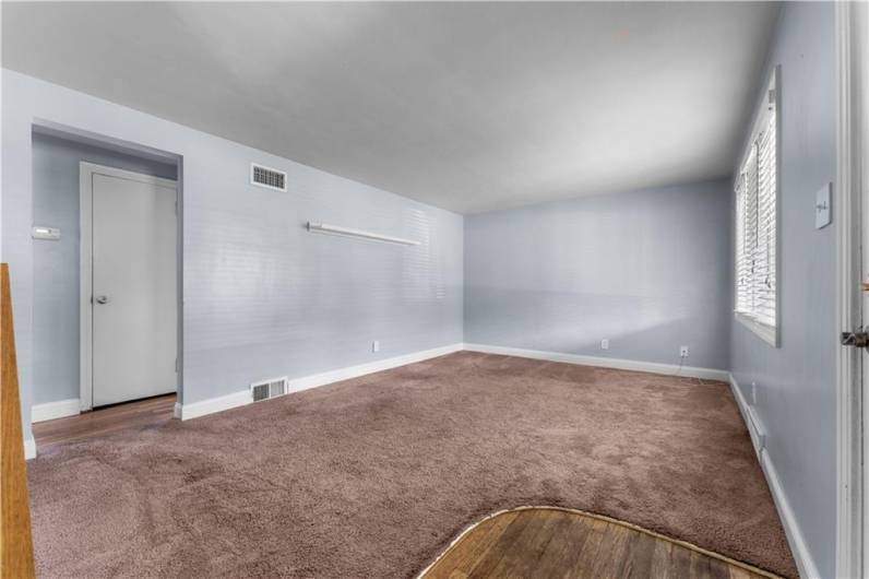 The Living Room features wall to wall carpeting, blinds (hardwood floors under carpet).