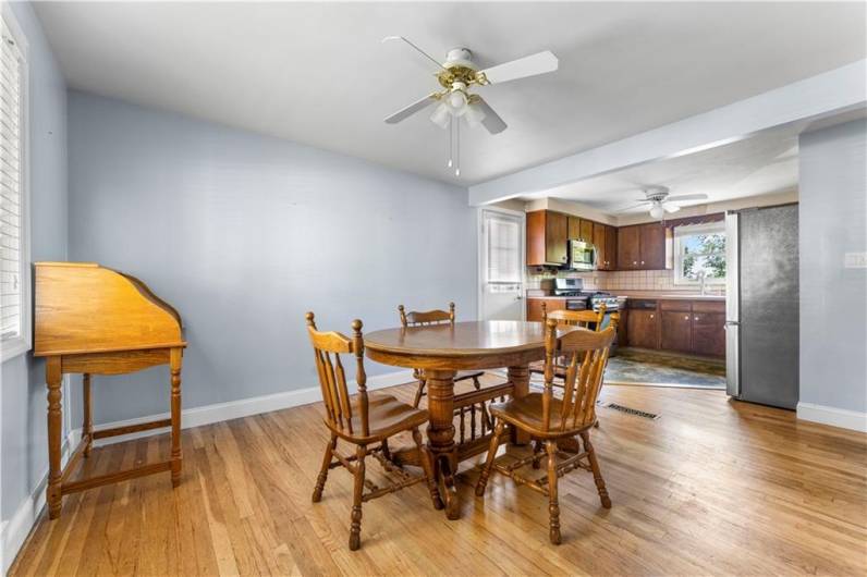 The Dining Room features hardwood floors, ceiling fan, blinds.  Open to the kitchen.