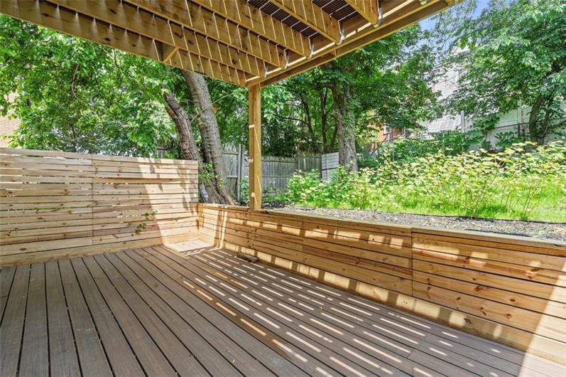 Large ground level deck with fenced yard access