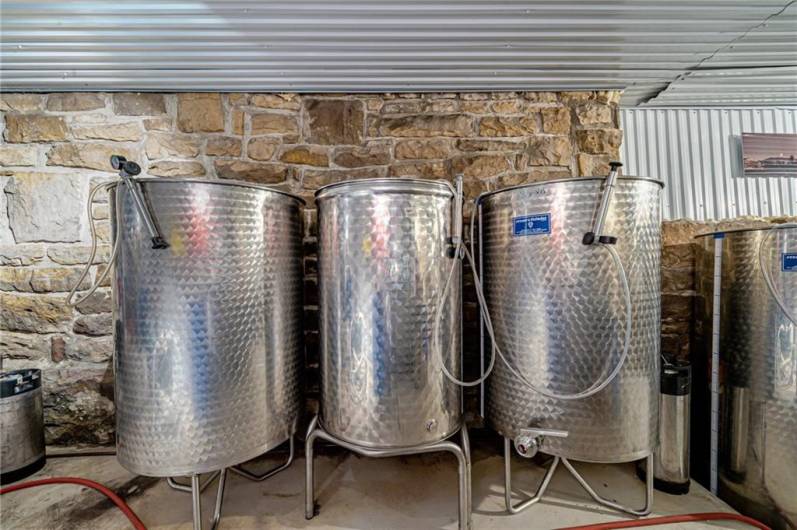 Temperature controlled room containing fermenter tanks.