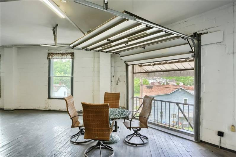 warehouse- large garage door opens up to let the sunshine and air in-table and chairs is included