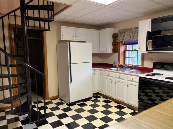 A SECOND FULL kitchen located in lower level...complete with an electric range/oven, refrigerator, and bar