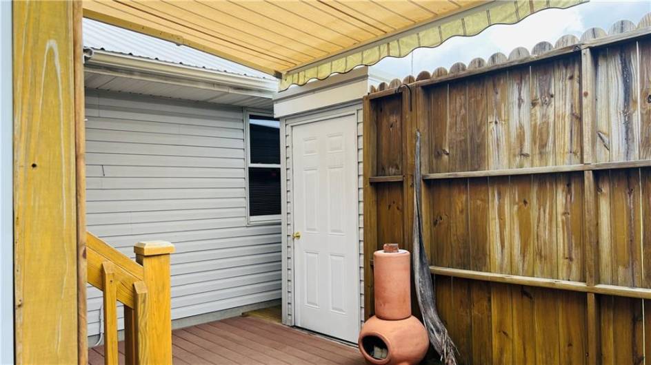 Enclosed deck with retractable awning