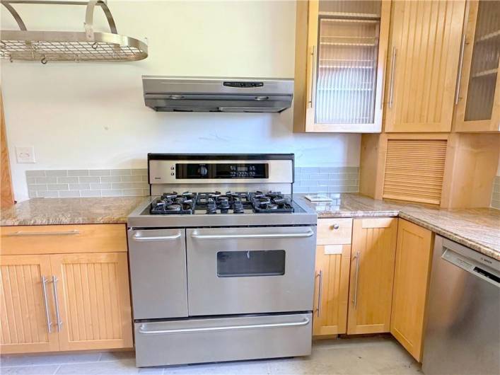 EXTRA KITCHEN DETAILS: The appliance caddy, the hanging pot rack, glass door fronts, upgraded gas stove, lazy-susan, and the down-lit exhaust hood, all create a delightful space to  prepare your meals!