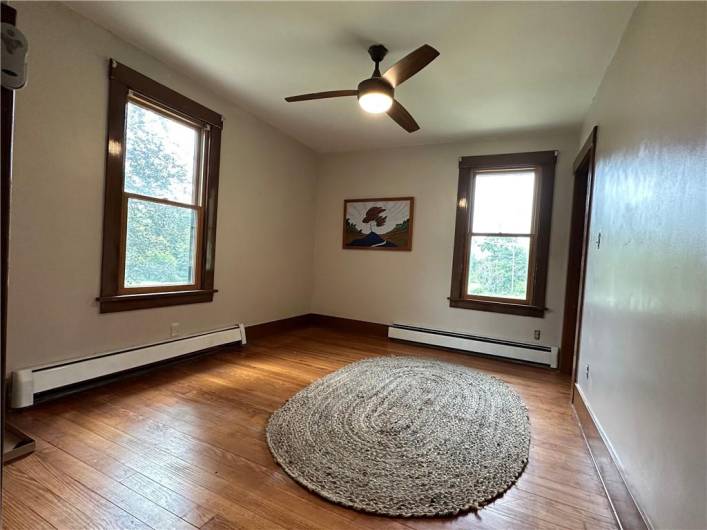 BEDROOM #4: This is the 15'x10' Bedroom on the main level, without the virtual staging, with the original oak flooring.  This room is so handy to the Kitchen that it could also be a great 1st floor Nursery, a Game Room or another Home Office.