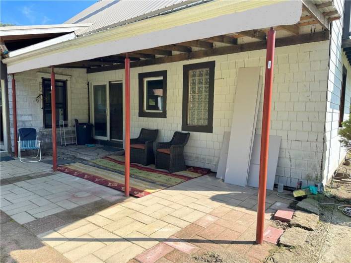 BACK PATIO FACES NORTH: This cozy back Patio is 22'x14'; half of which is under roof. It is perfect to watch the wildlife and enjoy the view towards the Barn and the treed acres.