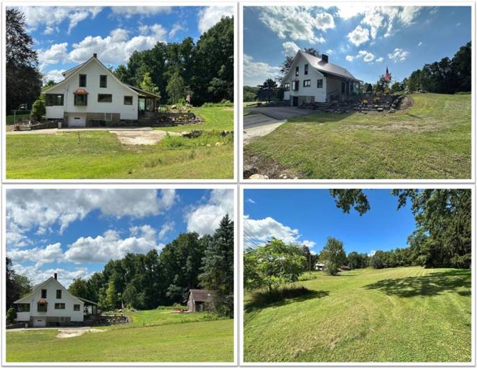 LOOKING EAST from the Kitchen window: This is the pasture in which George has long thought of putting a white fence and adding horses. Here you see the rock garden and the raised garden beds which add color; the woods provide great privacy.